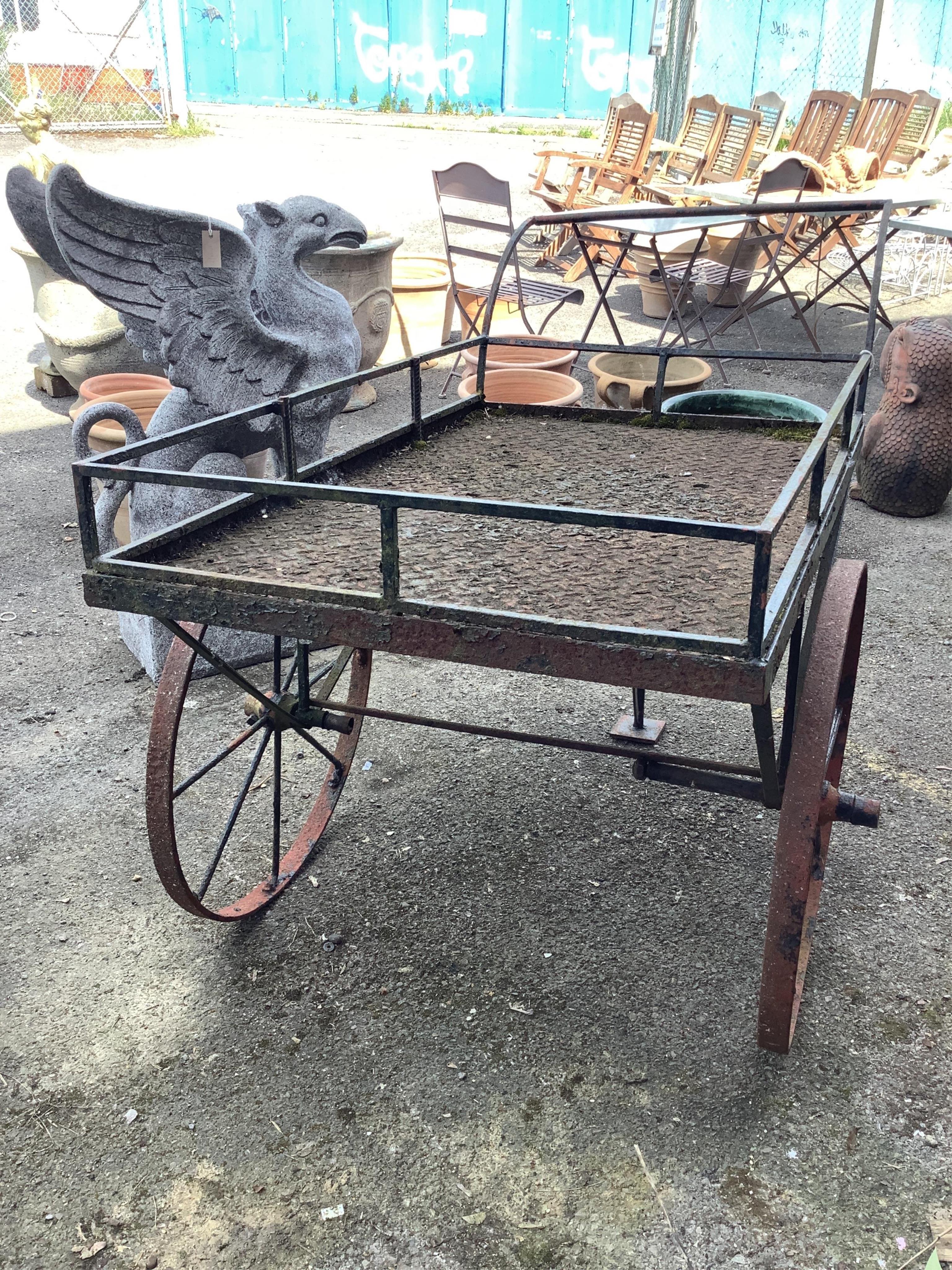 A wrought iron garden barrow, width 76cm, length 152cm, height 106cm